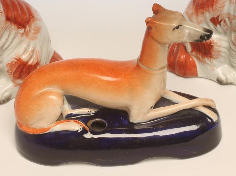 A SMALL PAIR OF VICTORIAN STAFFORDSHIRE POTTERY SPANIELS Image