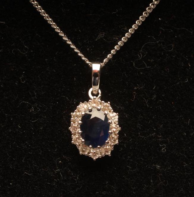 A SAPPHIRE AND DIAMOND CLUSTER PENDANT Image