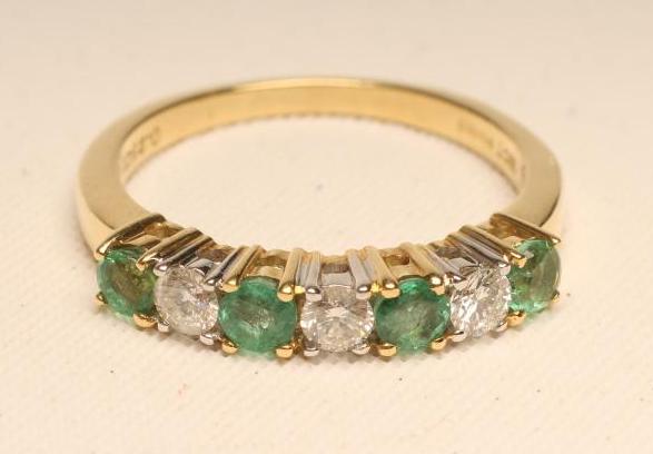 AN EMERALD AND DIAMOND HALF HOOP ETERNITY RING Image