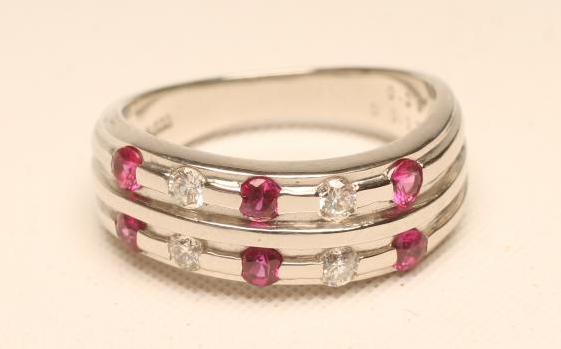A RUBY AND DIAMOND HALF HOOP RING Image