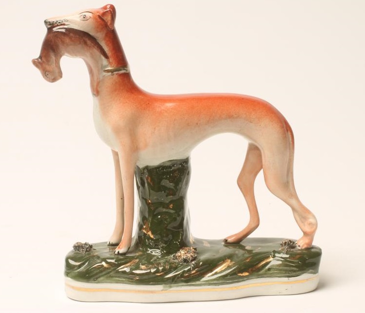 A VICTORIAN STAFFORDSHIRE POTTERY GREYHOUND Image