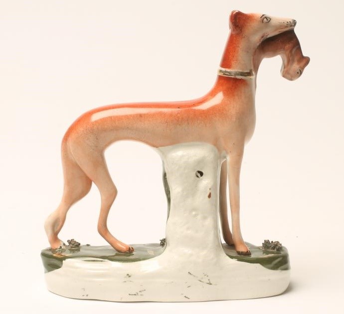 A VICTORIAN STAFFORDSHIRE POTTERY GREYHOUND Image