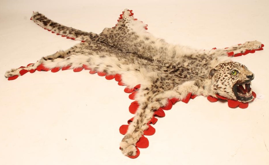 A SNOW LEOPARD SKIN RUG Image
