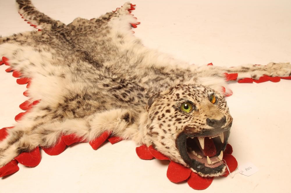 A SNOW LEOPARD SKIN RUG Image