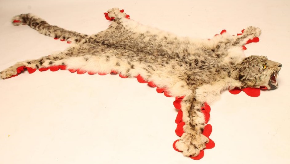 A SNOW LEOPARD SKIN RUG Image