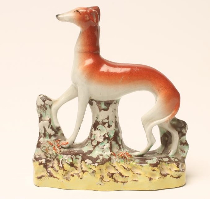 A VICTORIAN STAFFORDSHIRE POTTERY GREYHOUND Image