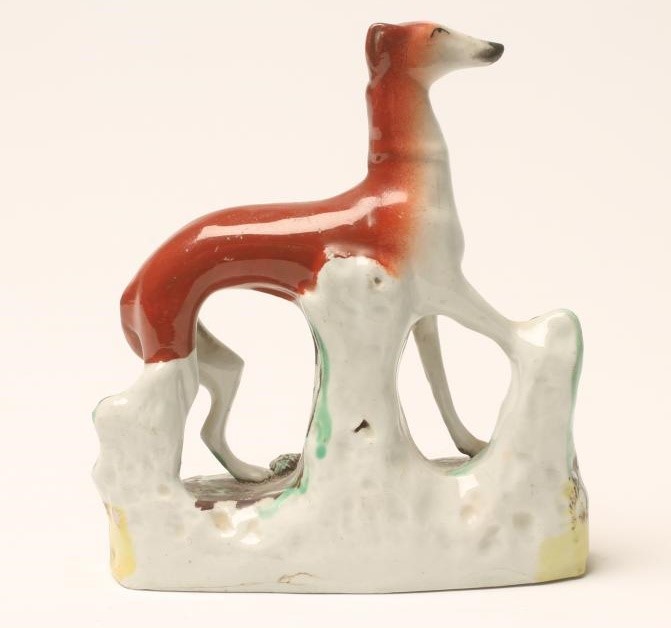 A VICTORIAN STAFFORDSHIRE POTTERY GREYHOUND Image