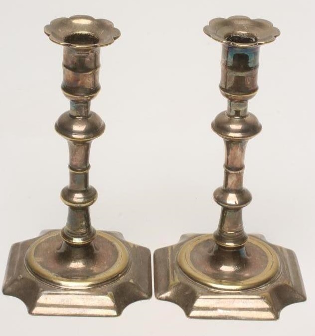 A PAIR OF GEORGIAN SILVERED BRASS CANDLESTICKS Image