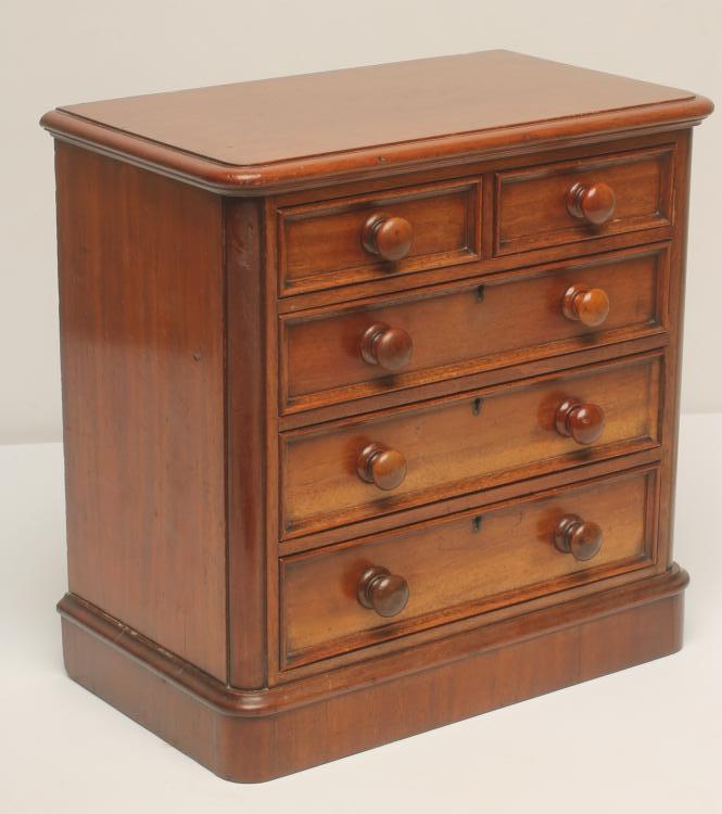 A VICTORIAN MAHOGANY MINIATURE CHEST of rounded oblong form Image