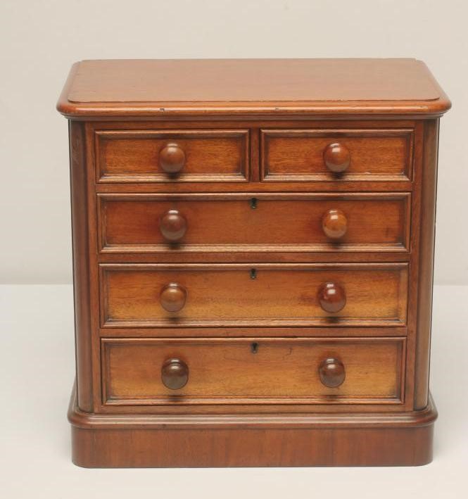 A VICTORIAN MAHOGANY MINIATURE CHEST of rounded oblong form Image