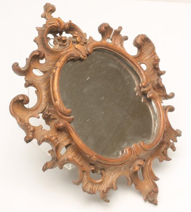 A CARVED LIMEWOOD WALL MIRROR Image