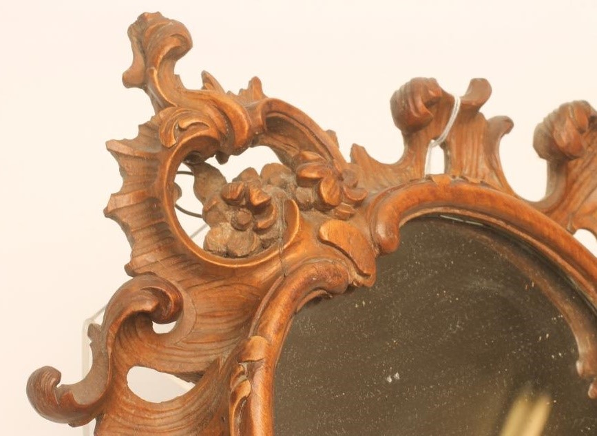 A CARVED LIMEWOOD WALL MIRROR Image