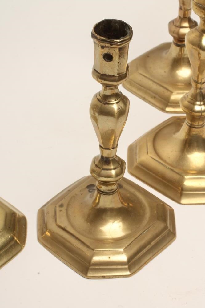 FOUR GEORGIAN BRASS CANDLESTICKS Image