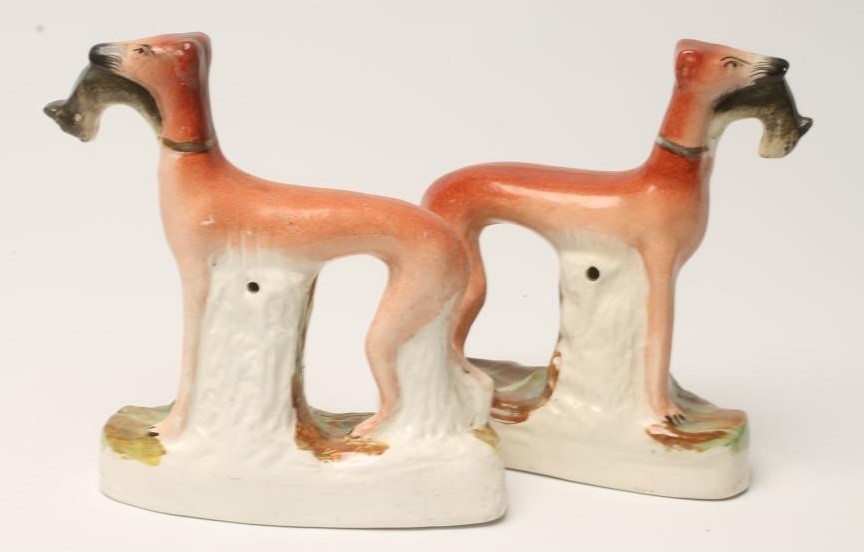 A PAIR OF VICTORIAN STAFFORDSHIRE POTTERY GREYHOUNDS Image