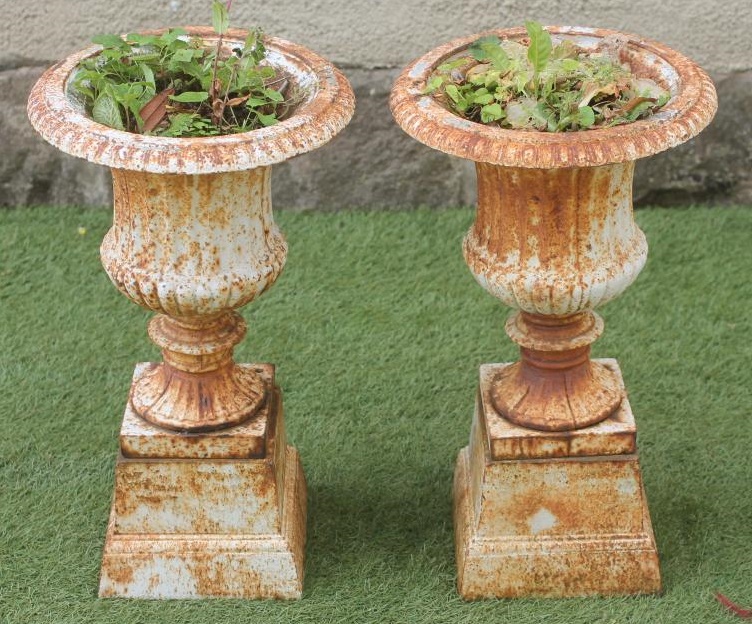 A PAIR OF SMALL CAST IRON URNS Image