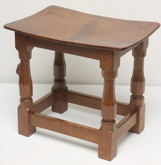 AN ADZED OAK STOOL by Robert Thompson of oblong form with dished seat Image