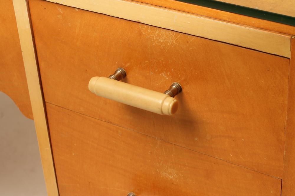 AN ART DECO SATIN BIRCH AND PAINTED SIDE TABLE of rounded oblong kneehole form Image