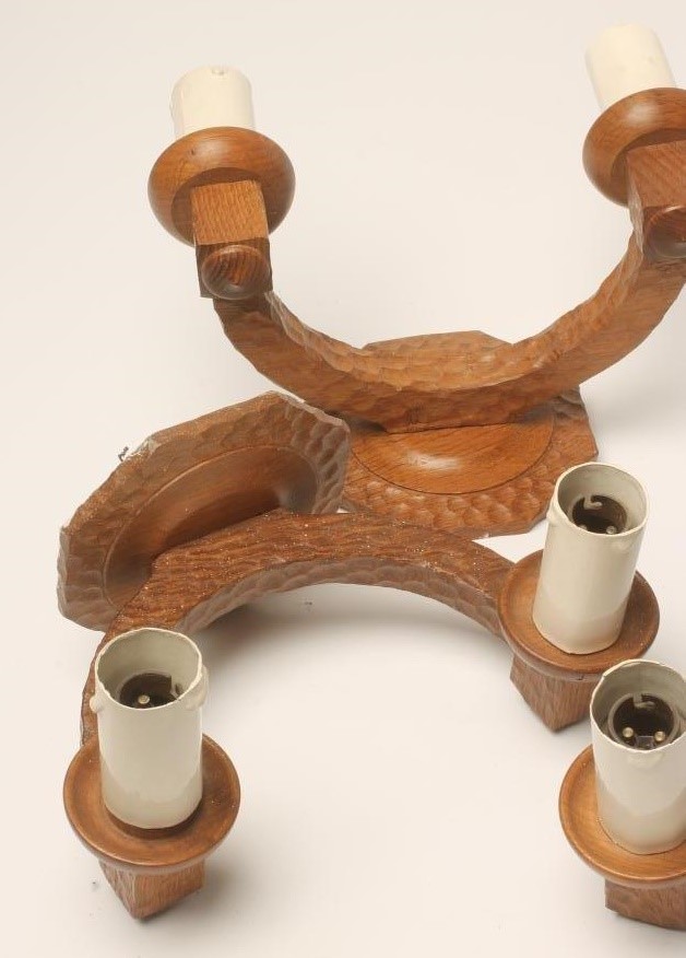 A SET OF SIX ADZED OAK WALL LIGHTS each crescent shaped support issuing a pair of sconces with faux Image