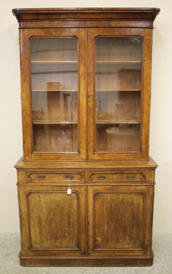A VICTORIAN BURR WALNUT BOOKCASE of two stage shallow rounded oblong form Image