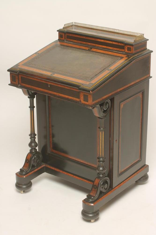 A VICTORIAN EBONISED AND PARCEL GILT DAVENPORT with stringing and amboyna banding Image