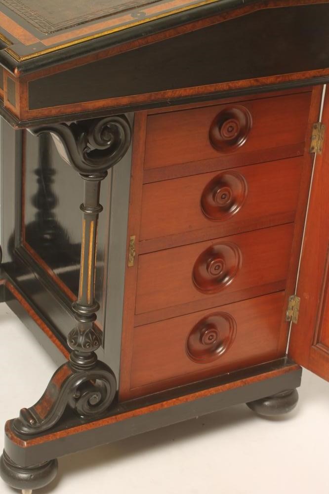 A VICTORIAN EBONISED AND PARCEL GILT DAVENPORT with stringing and amboyna banding Image
