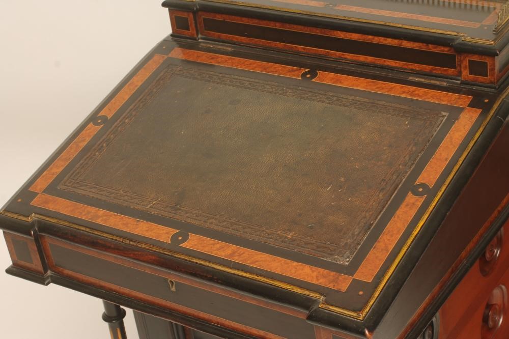 A VICTORIAN EBONISED AND PARCEL GILT DAVENPORT with stringing and amboyna banding Image