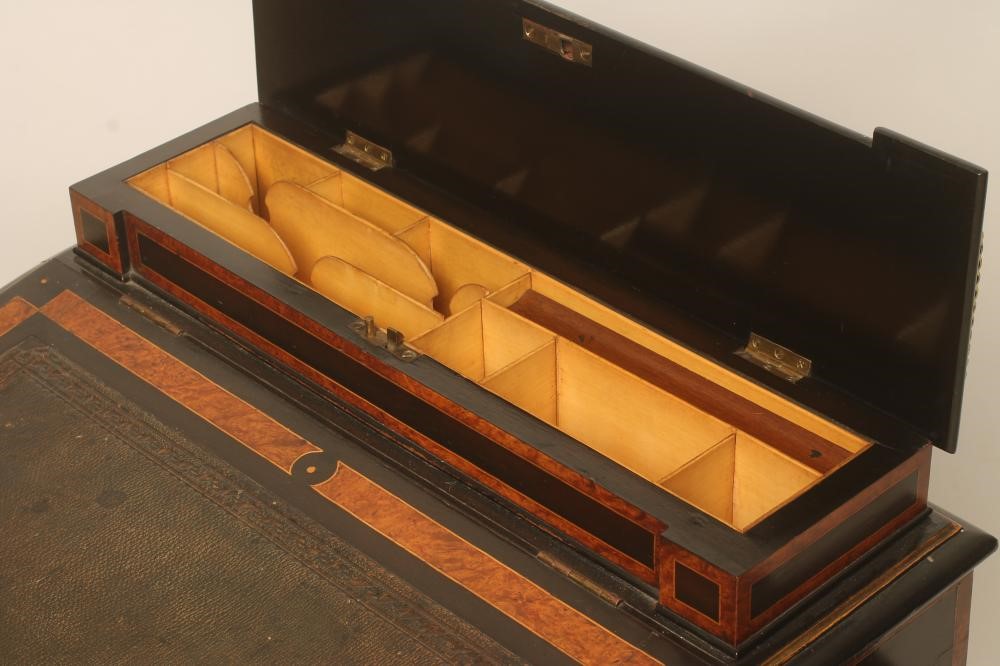 A VICTORIAN EBONISED AND PARCEL GILT DAVENPORT with stringing and amboyna banding Image