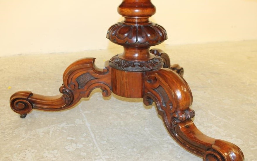 A VICTORIAN WALNUT BREAKFAST TABLE Image