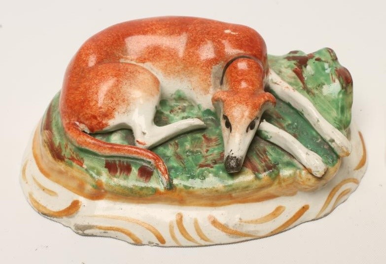 A PAIR OF VICTORIAN STAFFORDSHIRE POTTERY GREYHOUNDS Image