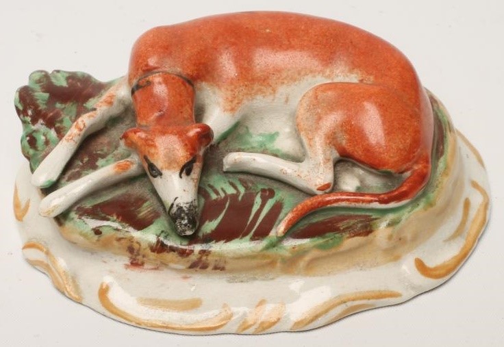 A PAIR OF VICTORIAN STAFFORDSHIRE POTTERY GREYHOUNDS Image