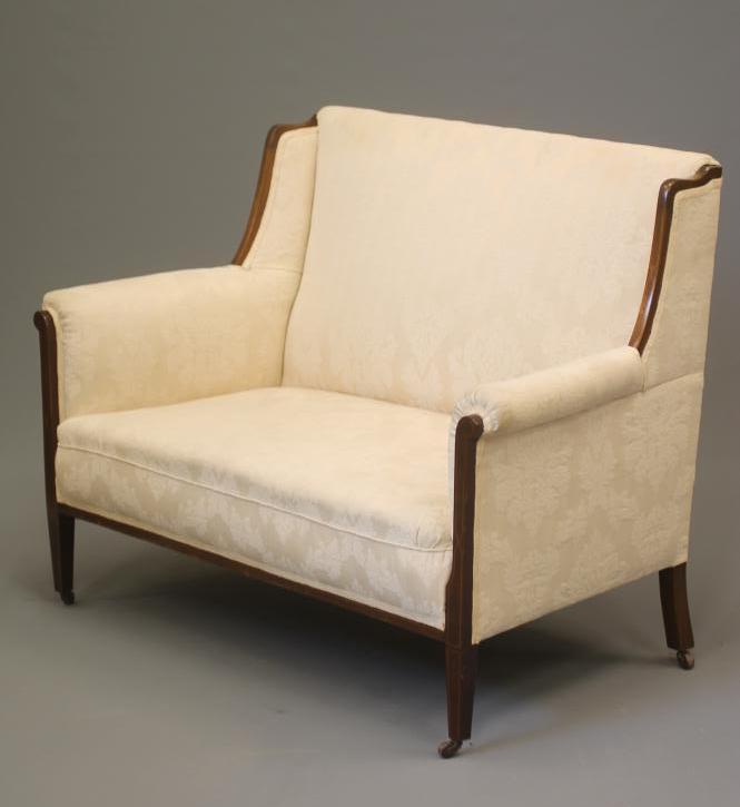 AN EDWARDIAN MAHOGANY FRAMED SOFA of high back form with stringing and upholstered in ivory damask Image