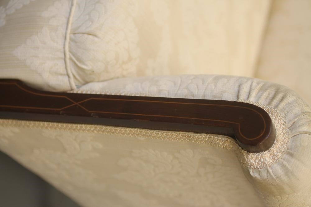 AN EDWARDIAN MAHOGANY FRAMED SOFA of high back form with stringing and upholstered in ivory damask Image