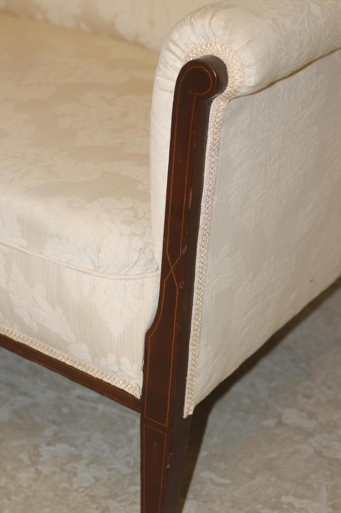 AN EDWARDIAN MAHOGANY FRAMED SOFA of high back form with stringing and upholstered in ivory damask Image