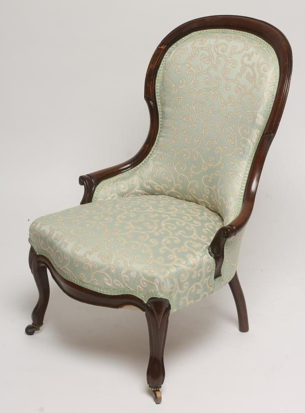 A VICTORIAN WALNUT FRAMED SALON CHAIR of spoonback form upholstered in a pale green and cream silk Image
