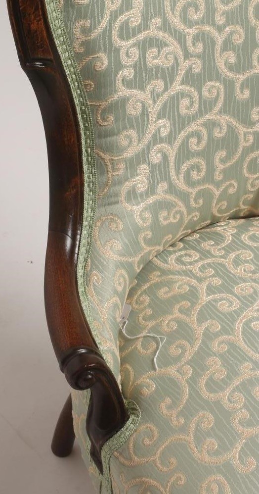 A VICTORIAN WALNUT FRAMED SALON CHAIR of spoonback form upholstered in a pale green and cream silk Image