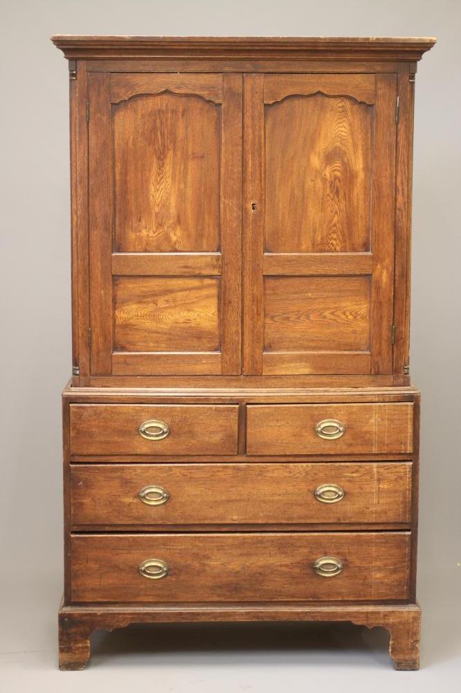 A GEORGIAN OAK PRESS CUPBOARD Image