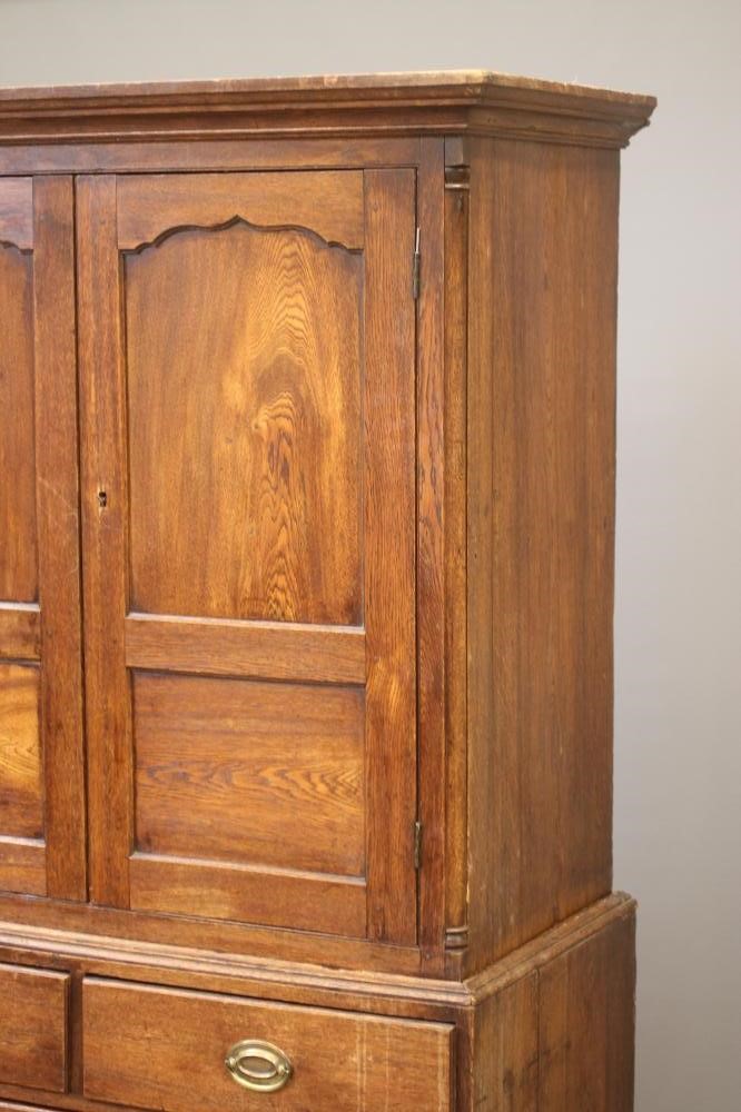 A GEORGIAN OAK PRESS CUPBOARD Image