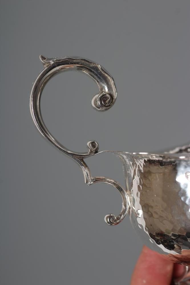 AN EDWARDIAN ARTS AND CRAFTS SILVER SAUCE BOAT Image