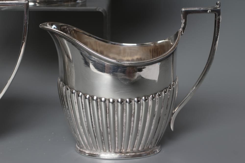 AN EDWARDIAN SILVER COMPOSITE THREE PIECE TEA SERVICE Image