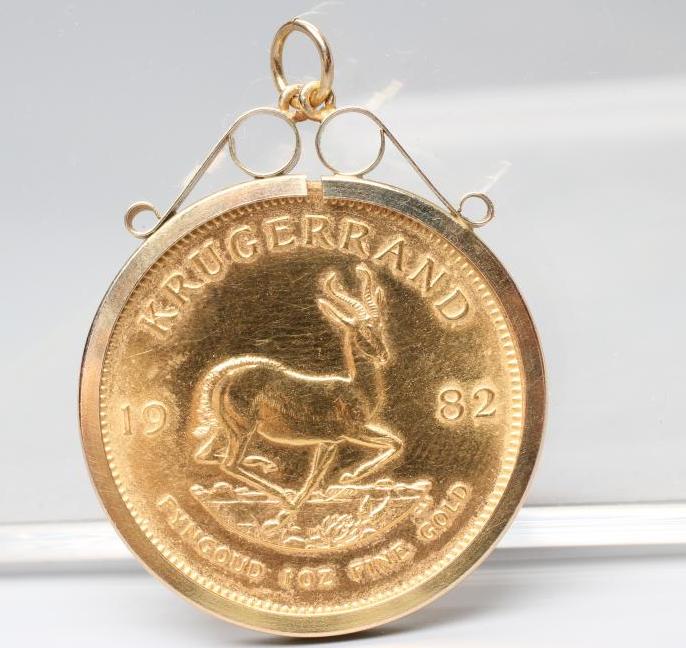 A KRUGERRAND, 1982, in a 9ct gold loose pendant mount, London 1992, 37.2g total (Est. plus 24% Image