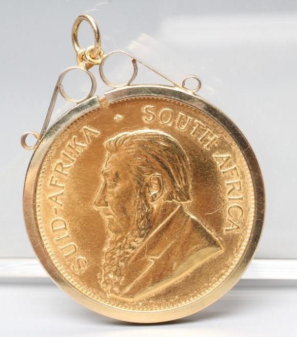 A KRUGERRAND, 1982, in a 9ct gold loose pendant mount, London 1992, 37.2g total (Est. plus 24% Image