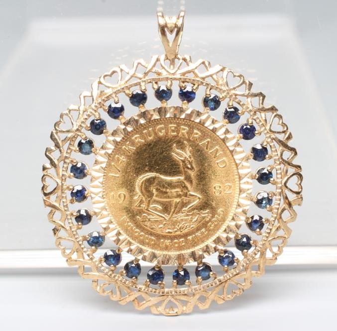 A ONE QUARTER KRUGERRAND, 1982, in a 9ct gold loose pendant mount claw set with numerous small Image