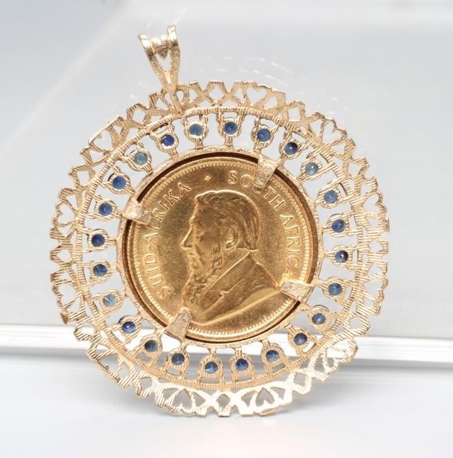 A ONE QUARTER KRUGERRAND, 1982, in a 9ct gold loose pendant mount claw set with numerous small Image
