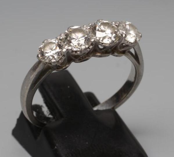 A FOUR STONE DIAMOND RING, the old brilliant cut stones each of approximately 0.23cts, claw set to a Image
