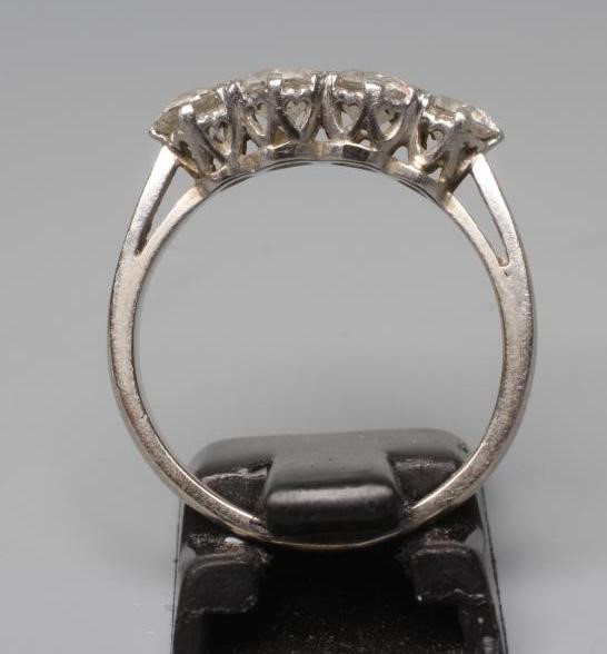 A FOUR STONE DIAMOND RING, the old brilliant cut stones each of approximately 0.23cts, claw set to a Image