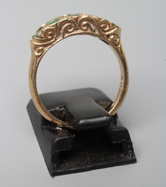 A FIVE STONE EMERALD HALF HOOP RING, the oval facet cut stones collet set to a plain 9ct gold shank, Image