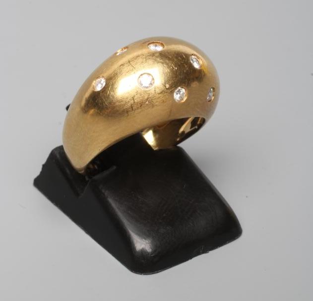 A DIAMOND DRESS RING, the domed panel gypsy set with ten small stones to a plain 18ct gold shank, Image