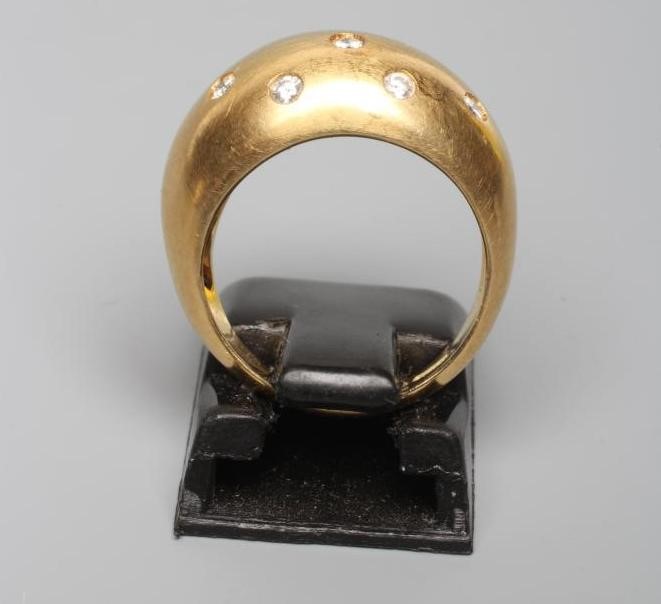 A DIAMOND DRESS RING, the domed panel gypsy set with ten small stones to a plain 18ct gold shank, Image
