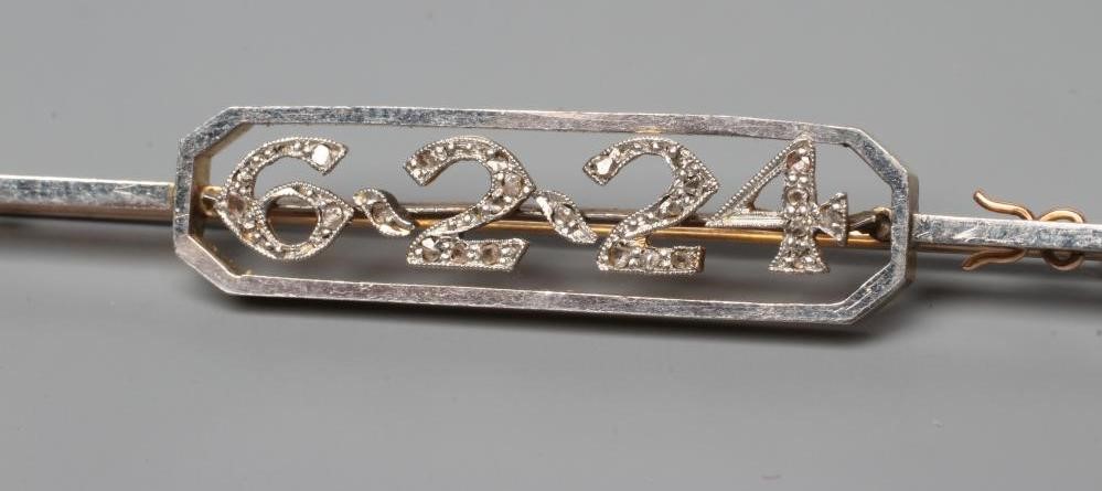 A DIAMOND "DATE" BAR BROOCH, the open canted panel centred by the date 6.2.24, the numerals all pave Image