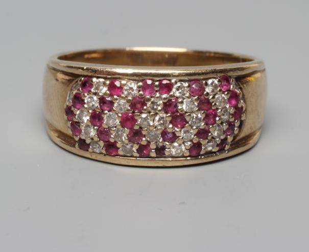 A RUBY AND DIAMOND DRESS RING, the oval panel point set with numerous small diamonds and rubies to a Image